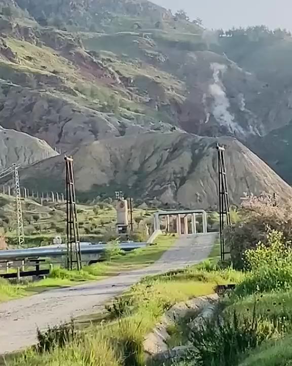 Geothermal power plant in a landscape at dusk
